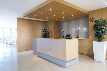 An IMS Legal reception desk next to a plant in a welcoming atmosphere