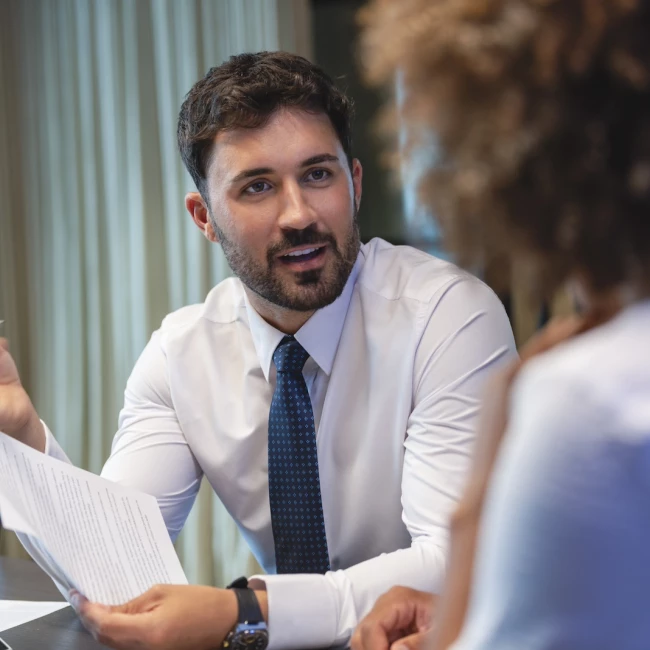 A man in a business suit engages in conversation about legal strategies