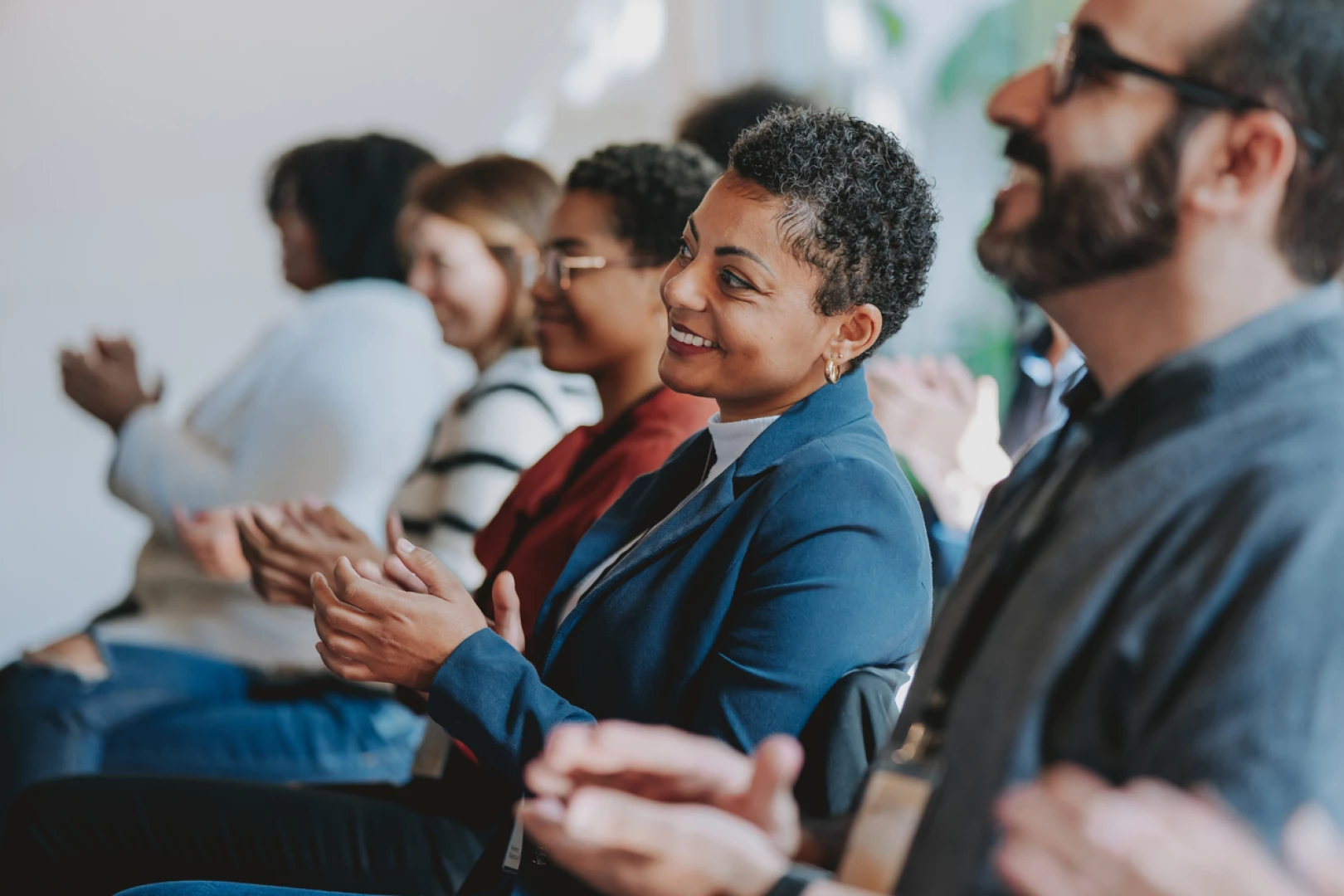 A diverse group of individuals a meeting, promoting diversity, equity, inclusion & belonging