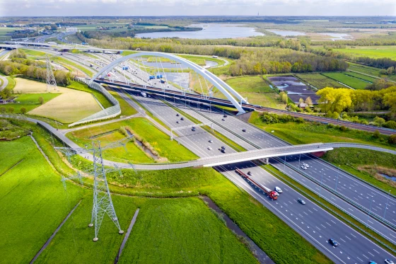 A massive bridge spanning over a busy highway facilitating transportation