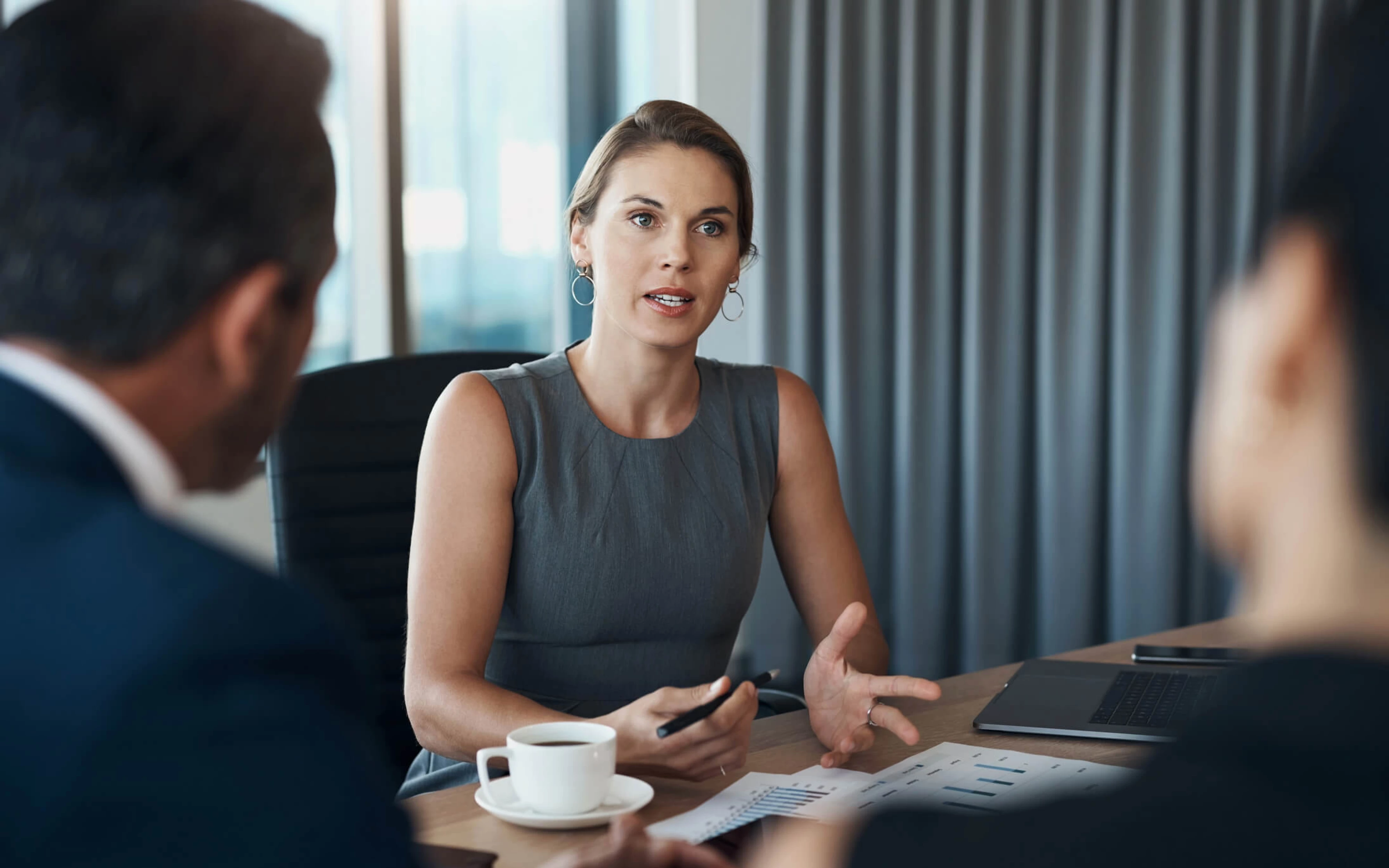 A woman and a man engaged in discussion during a legal meeting