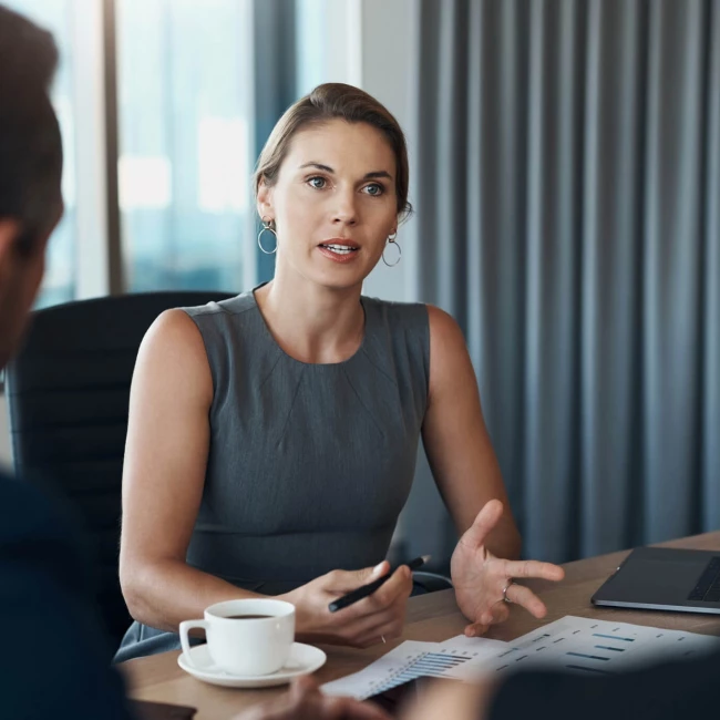 A woman and a man engaged in discussion during a legal meeting