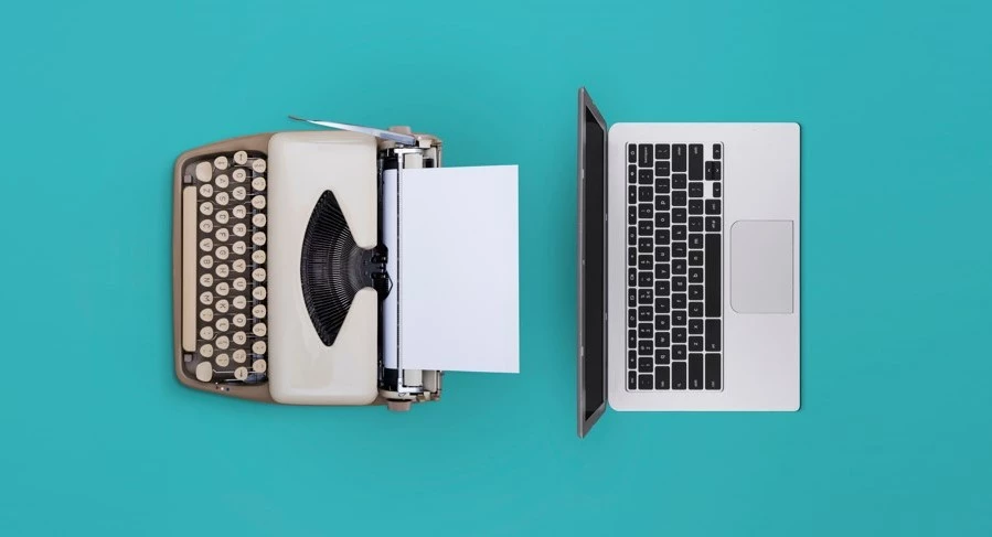 Laptop Alongside a Printout Machine in a Workspace