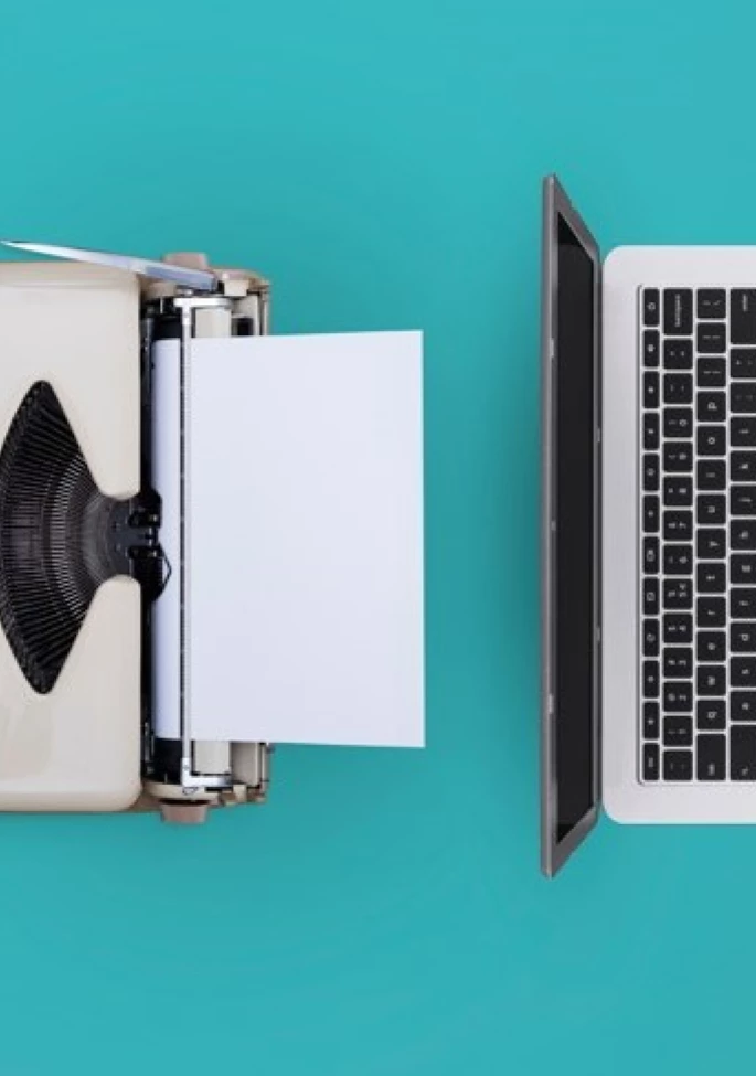 Laptop Alongside a Printout Machine in a Workspace