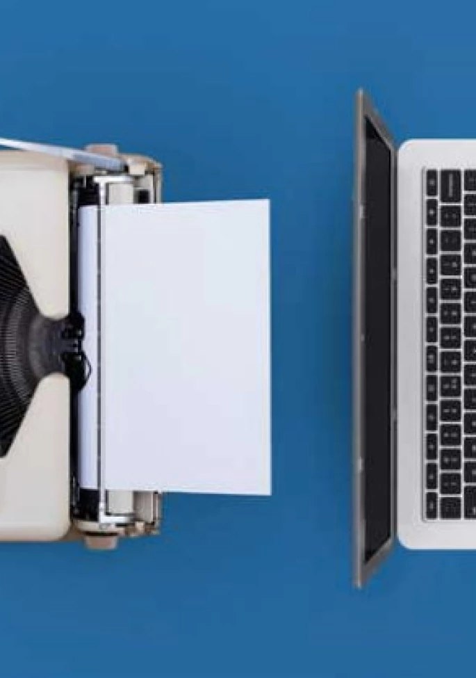 Laptop Alongside a Printout Machine in a Workspace