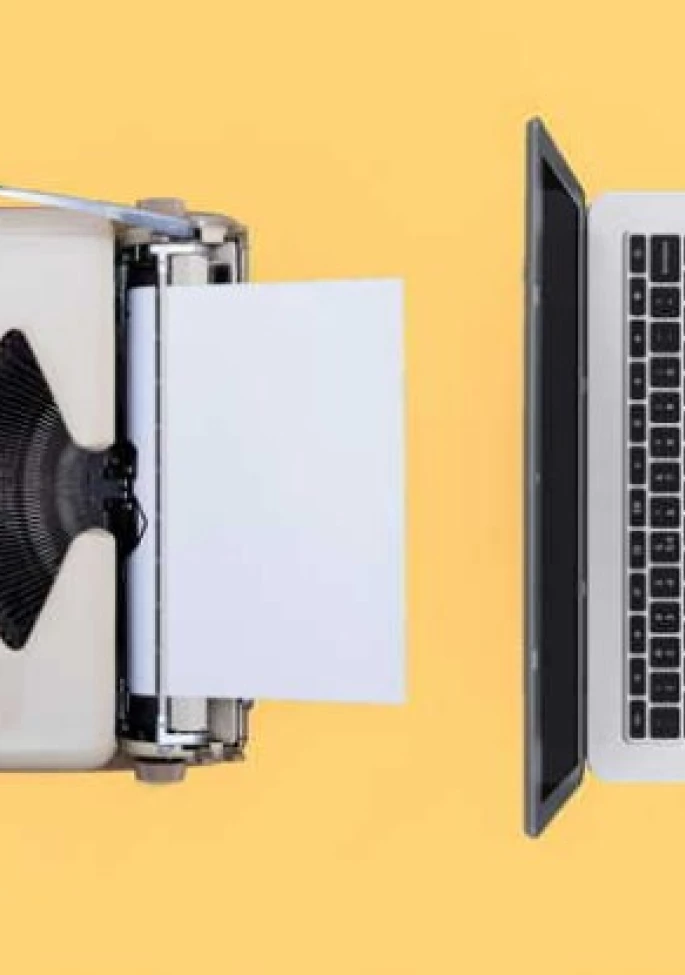 Laptop Alongside a Printout Machine in a Workspace