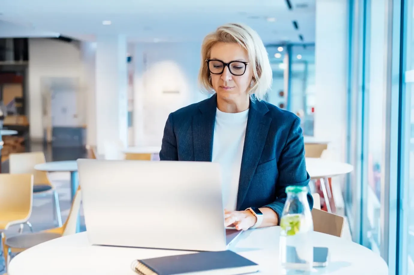 A woman Attorney reading about cases on a laptop in an office