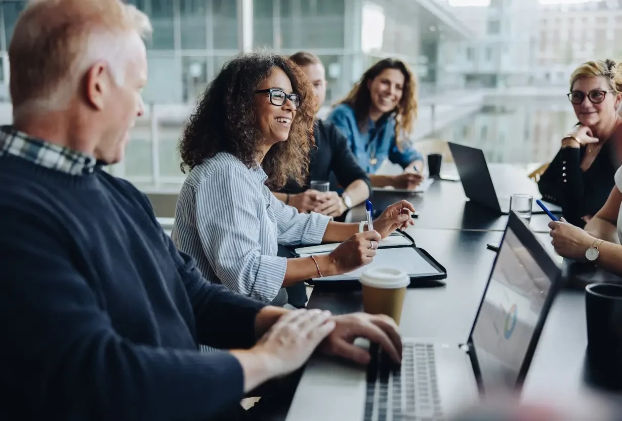 A group of legal consultants sitting around a table engaged in a press discussion