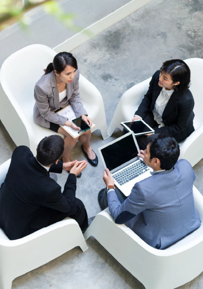 A group of business professionals engaged in a discussion about legal strategies