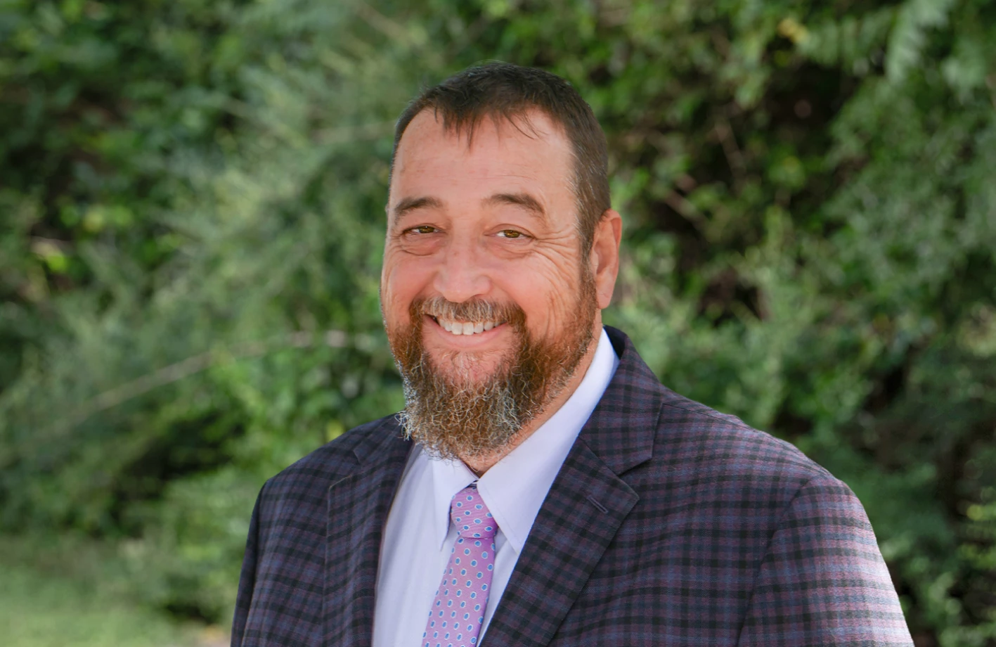 Jody Braxton, in a suit with a beard, serves as a Solution Advisor at IMS Legal Strategies