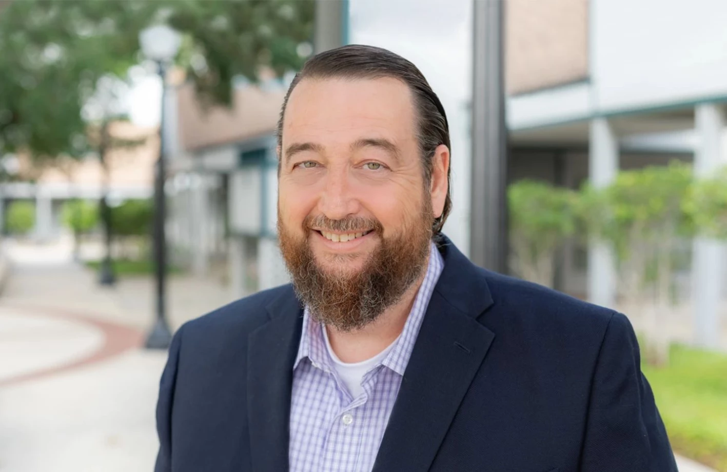 Jody Braxton, in a suit with a beard, serves as a Solution Advisor at IMS Legal Strategies