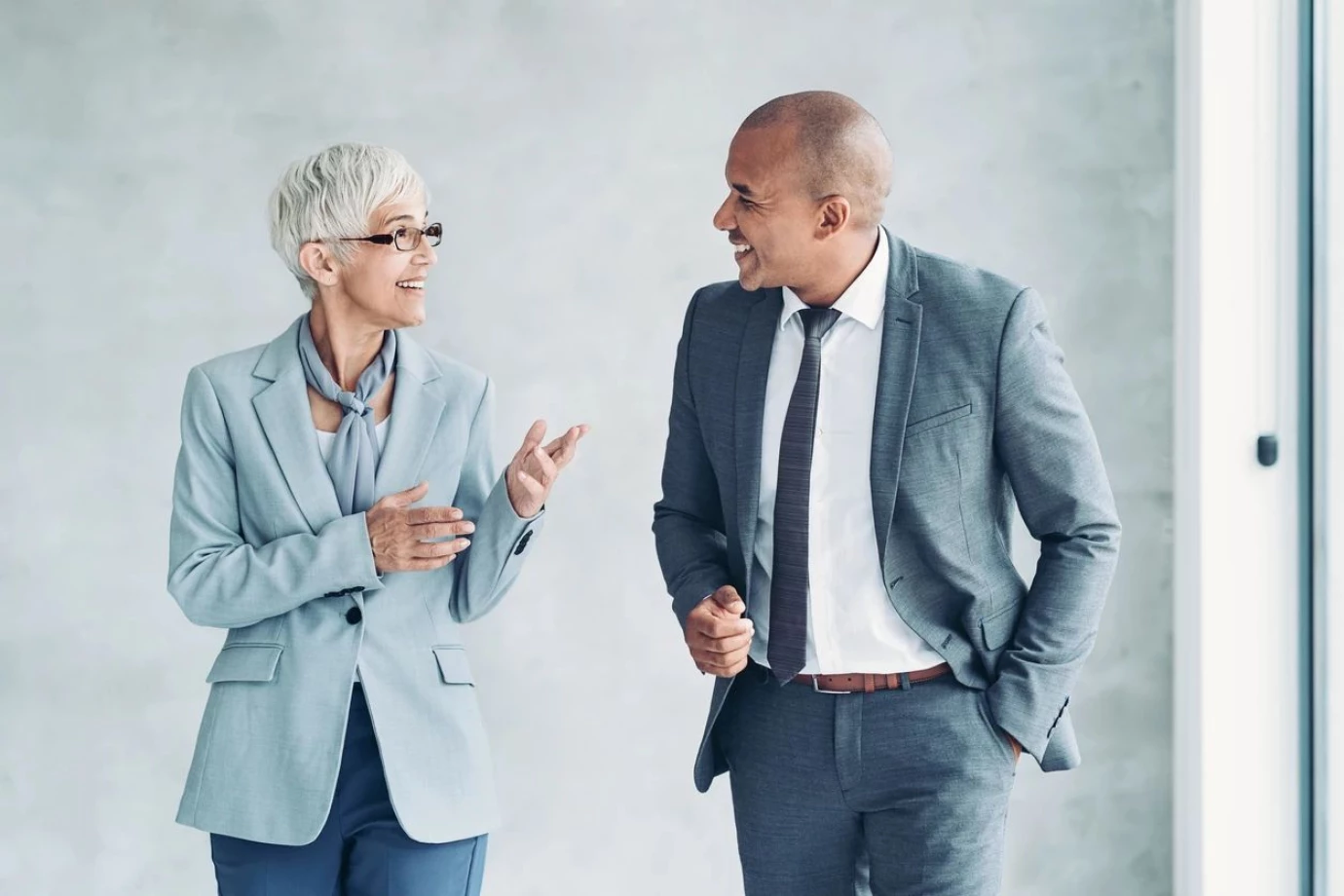 Two business professionals engage in conversation at IMS Legal Strategies